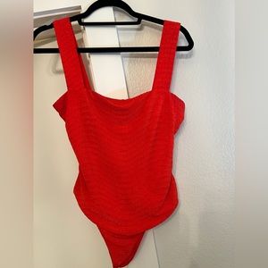 Red revolve bodysuit. Privacy Please